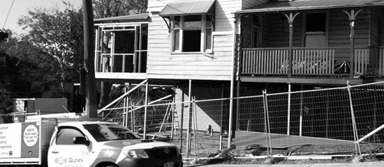 Black and white image of Bob Gunn vehicle in front of a house
